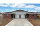 Duplex with two-car garages and brick facade at 5837 Newcombe Ct, Arvada, CO 80004