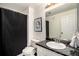 Clean bathroom with a marble vanity and a black shower curtain at 3231 E 103Rd Pl # 308, Thornton, CO 80229