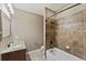 Clean bathroom with a shower/tub combo and granite vanity at 59304 E Commanche Way, Strasburg, CO 80136