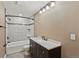 Basement bathroom with tub, shower, and dark vanity at 59304 E Commanche Way, Strasburg, CO 80136