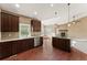 Spacious kitchen with island, stainless steel appliances, and hardwood floors at 59304 E Commanche Way, Strasburg, CO 80136