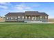 Ranch style home with gray siding, red shutters, and a spacious lawn at 59304 E Commanche Way, Strasburg, CO 80136