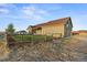 Home's backyard features a fenced yard and a detached garage at 59304 E Commanche Way, Strasburg, CO 80136