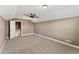 Spacious bedroom with ceiling fan and access to hallway at 59304 E Commanche Way, Strasburg, CO 80136