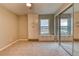 Bedroom with mirrored closet doors and city view at 2 Adams St # 1204, Denver, CO 80206