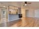 Open living room with hardwood floors and kitchen island at 2 Adams St # 1204, Denver, CO 80206