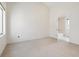 Bright bedroom with neutral carpeting and en-suite bathroom access at 2312 S University Blvd, Denver, CO 80210