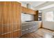 Modern kitchen with wood cabinetry and stainless steel appliances at 2312 S University Blvd, Denver, CO 80210