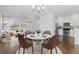 Bright dining area with seating for four, adjacent to a modern kitchen and living room at 14753 E Crestridge Dr, Centennial, CO 80015