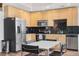 Kitchen with stainless steel appliances, a black tile backsplash, and a dining table at 1700 Bassett St # 1319, Denver, CO 80202