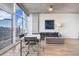 Living room with city views, dining table, couch, and hardwood flooring at 1700 Bassett St # 1319, Denver, CO 80202