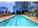 Community pool surrounded by lounge chairs and landscaping at 1700 Bassett St # 1319, Denver, CO 80202