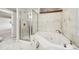 Modern bathroom featuring a corner jacuzzi tub and a separate shower at 1949 Spruce Ct, Erie, CO 80516