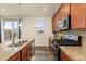 Well-equipped kitchen featuring granite countertops and gas range at 12897 Creekwood St, Firestone, CO 80504