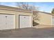 Attached two-car garage with individual garage doors at 930 Button Rock Dr # J59, Longmont, CO 80504