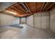 Unfinished basement with exposed beams and window at 930 Button Rock Dr # J59, Longmont, CO 80504