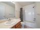 Main bathroom with tub, shower, and wood vanity at 930 Button Rock Dr # J59, Longmont, CO 80504