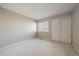 Simple bedroom with carpet, window, and double doors at 930 Button Rock Dr # J59, Longmont, CO 80504