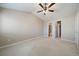 Primary bedroom with ceiling fan and access to bathroom and closet at 930 Button Rock Dr # J59, Longmont, CO 80504