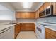 Efficient kitchen with wood cabinets and stainless steel appliances at 930 Button Rock Dr # J59, Longmont, CO 80504
