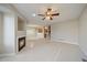 Living room with fireplace, carpet, and access to dining area at 930 Button Rock Dr # J59, Longmont, CO 80504