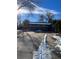 Brick ranch home with a large driveway and mature trees at 3273 S Florence Ct, Denver, CO 80231