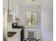 Small kitchen with white cabinets and black and white floor at 85 N Grant St # 22, Denver, CO 80203