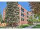 Brick building with green awnings and landscaping at 85 N Grant St # 22, Denver, CO 80203