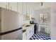 Small kitchen with white cabinets and black and white floor at 85 N Grant St # 22, Denver, CO 80203