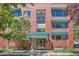 Brick building with green awnings and entrance at 85 N Grant St # 22, Denver, CO 80203