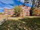 Large backyard with grass, trees, and building view at 85 N Grant St # 22, Denver, CO 80203