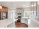 Modern kitchen with white cabinets, quartz countertops, and stainless steel appliances at 8095 E 128Th Pl, Thornton, CO 80602