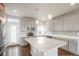 Modern kitchen with white cabinets, quartz countertops, and stainless steel appliances at 8095 E 128Th Pl, Thornton, CO 80602