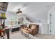 Game room with a leather couch, shelving, and a view from a window at 9502 Silver Spur Ln, Highlands Ranch, CO 80130