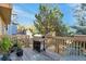 Back deck with grill, planters, and seating area, perfect for outdoor entertaining at 24087 Deer Valley Rd, Golden, CO 80401