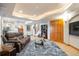 Finished basement features a comfortable sitting area, large TV, and ample storage at 24087 Deer Valley Rd, Golden, CO 80401