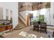 Two-story living room with hardwood floors, dining area, and high ceilings at 24087 Deer Valley Rd, Golden, CO 80401