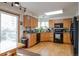 Well-equipped kitchen with light wood cabinets, granite counters, and black appliances at 24087 Deer Valley Rd, Golden, CO 80401