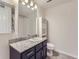 Bathroom with granite countertop, dark brown vanity, and shower/tub combo at 4100 Albion St # 512, Denver, CO 80216