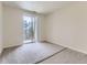 Bright bedroom with carpet flooring and sliding door to balcony at 4100 Albion St # 512, Denver, CO 80216