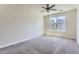 Spacious bedroom featuring carpet, large window, and ceiling fan at 4100 Albion St # 512, Denver, CO 80216