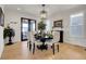 Formal dining room with dark wood table and access to the backyard at 27553 E Euclid Dr, Aurora, CO 80016