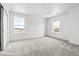 Well-lit bedroom with carpet and two windows at 3391 N Buchanan Way, Aurora, CO 80019
