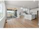 Open concept kitchen with white cabinets, island, and view to backyard at 3391 N Buchanan Way, Aurora, CO 80019