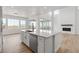 Modern kitchen with white cabinets, large island, and stainless steel appliances at 3391 N Buchanan Way, Aurora, CO 80019