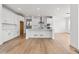 Modern kitchen boasts white cabinets, expansive island, and stainless steel appliances at 3391 N Buchanan Way, Aurora, CO 80019