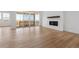 Bright living room featuring hardwood floors, fireplace, and sliding doors to backyard at 3391 N Buchanan Way, Aurora, CO 80019