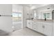 Modern bathroom with double vanity and large mirror at 3391 N Buchanan Way, Aurora, CO 80019