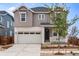 Two-story house with a modern design, featuring a neutral color palette and a two-car garage at 3391 N Buchanan Way, Aurora, CO 80019