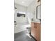 Modern bathroom with a bathtub, floating vanity, and subway tile at 1262 N Stuart St # 2, Denver, CO 80204